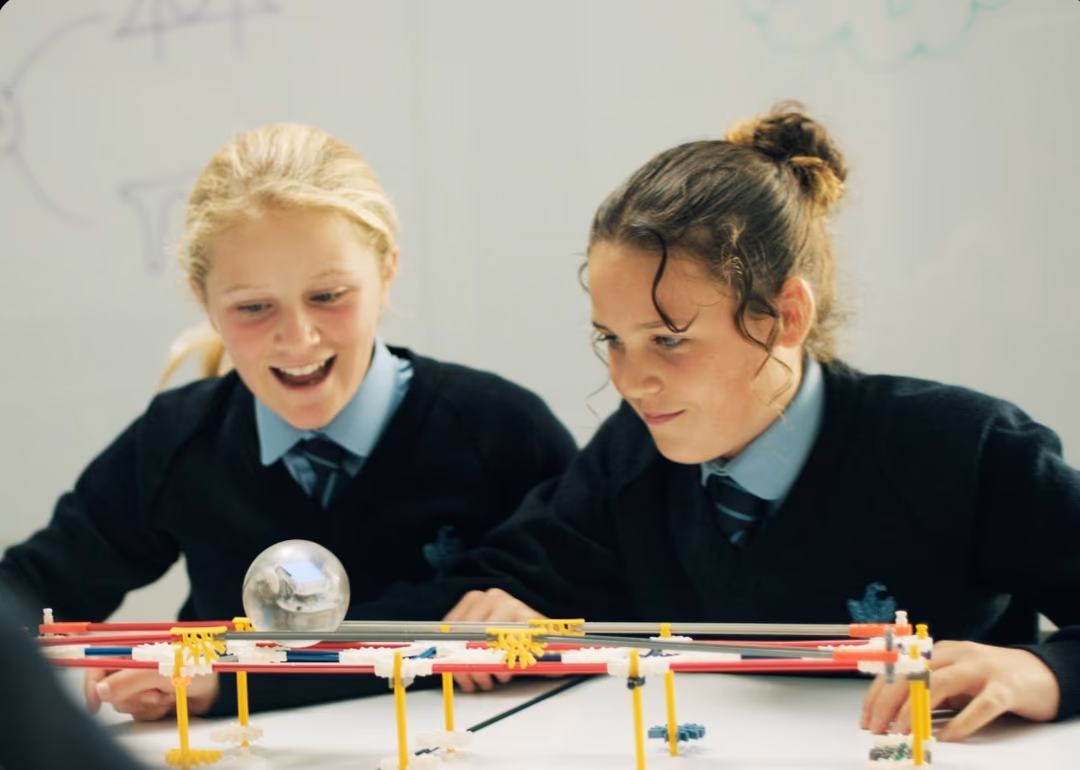 Two Form 2 (Year 7) girls programming a Sphero to travel across their bridge with the aid of their iPads.
